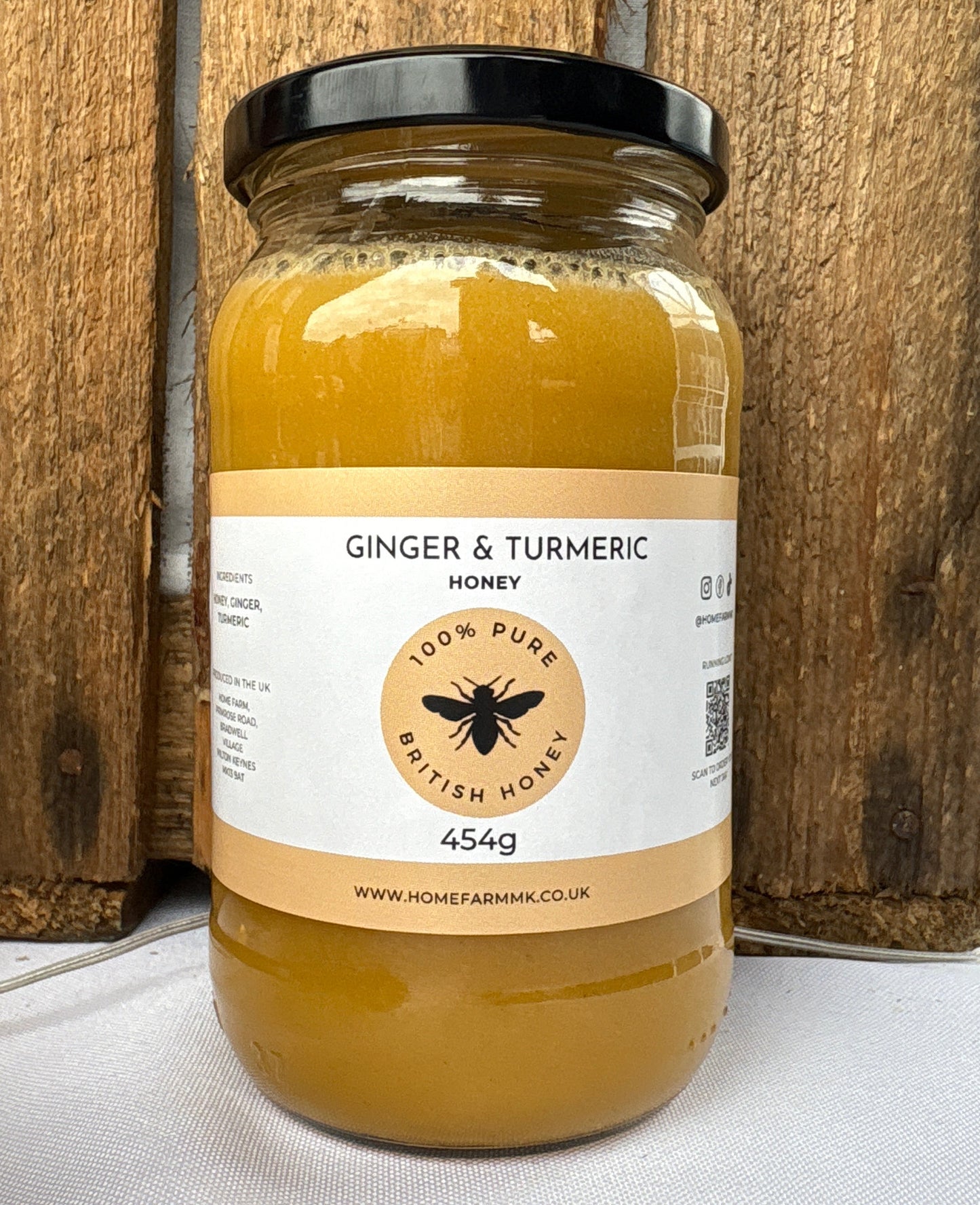 Jar of honey with ginger and turmeric on a wooden background