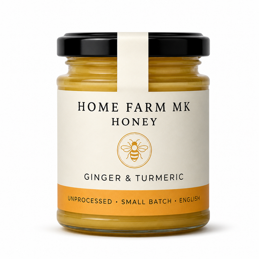 A jar of Home Farm Mk Ginger & Turmeric Honey with a black lid and cream label, set against a plain white background.