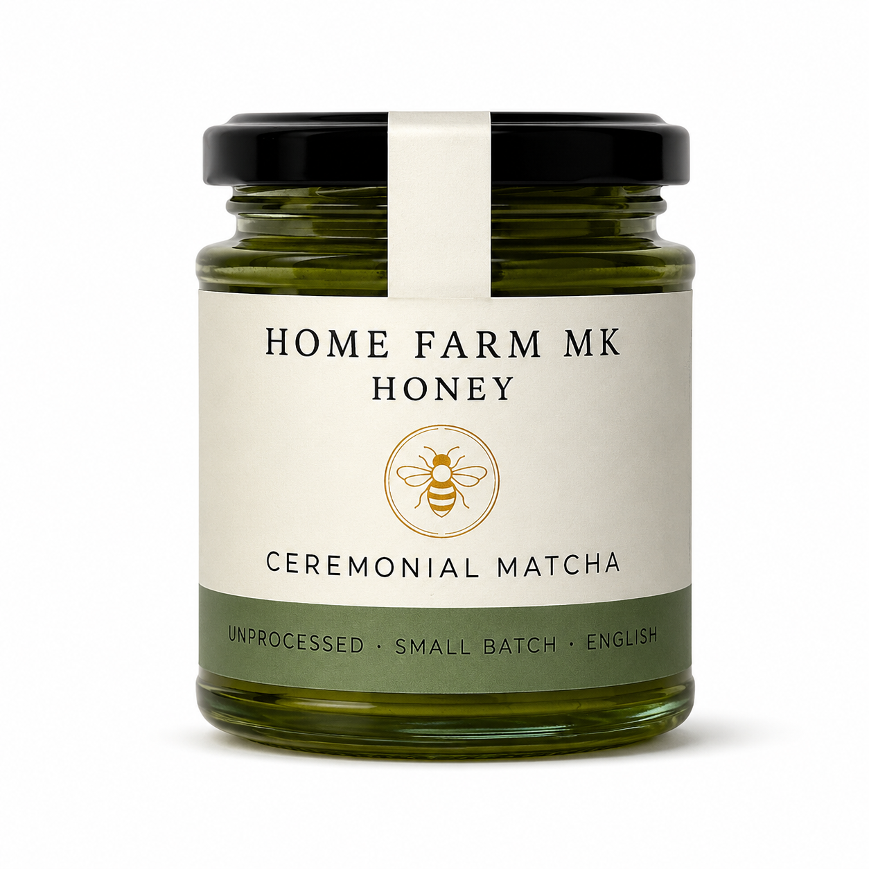 A glass jar of Home Farm MK Honey with Ceremonial Matcha flavor, featuring a cream-colored label with a gold bee logo and a black lid, set against a plain white background.