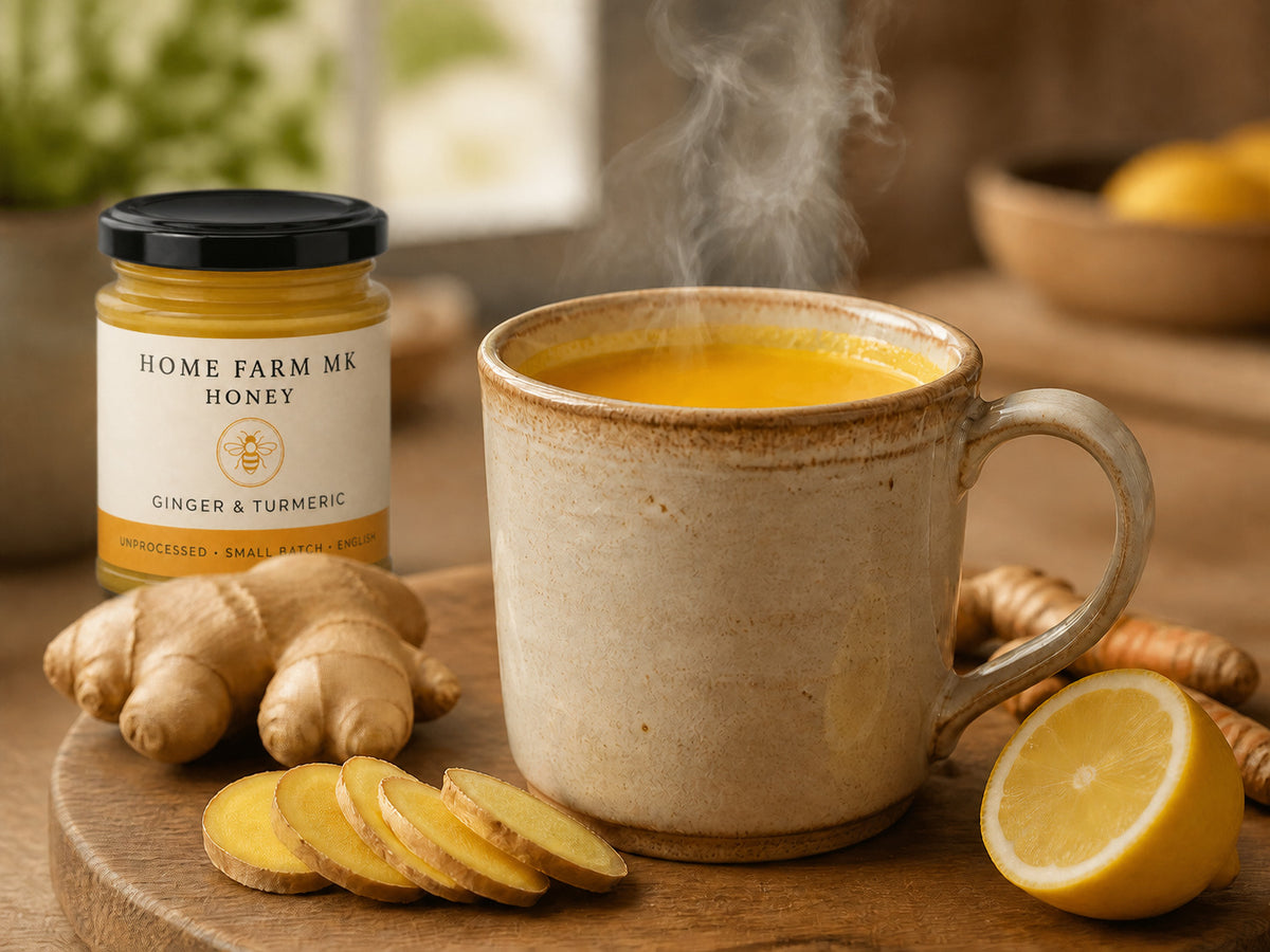 A warming ginger and turmeric honey drink beside fresh ginger and Ginger & Turmeric Honey.